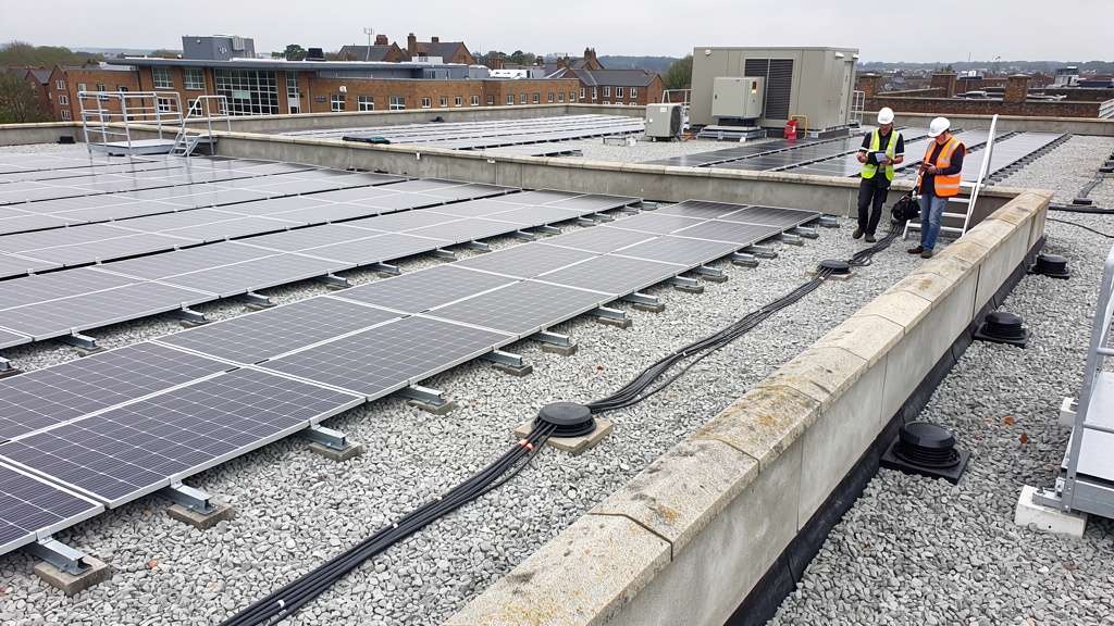Commercial flat roof with EPDM membrane and solar panels being assessed during professional survey