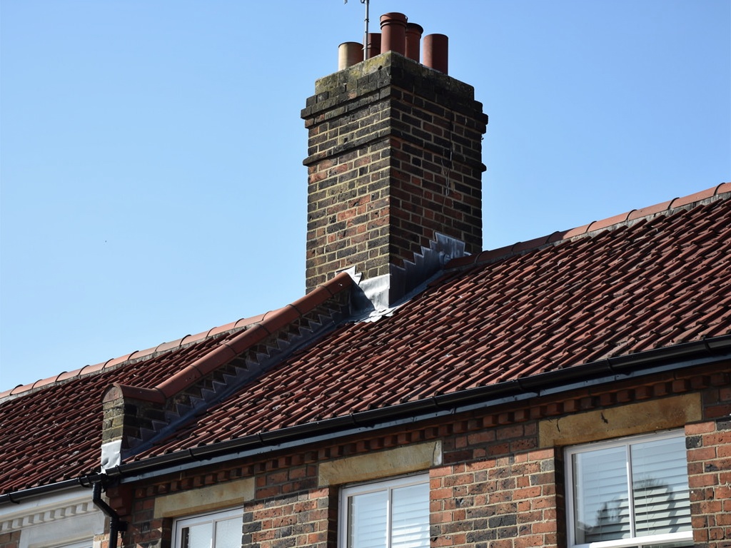 Victorian terraced house with clay tile roof and chimney stack — a common property type for pre-purchase roof surveys in the UK